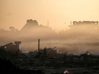 Morning fog covers heavily-damaged buildings in Deir el-Balah (Credit: AFP)