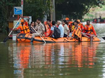 NDRF perso<em></em>nnel rescue residents of the flooded Kendriya Vihar apartment after heavy rain, in Bengaluru on October 22. (Image: PTI/Shailendra Bhojak) 